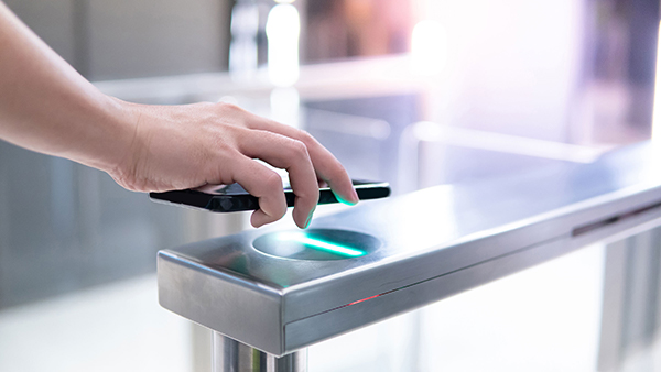 Hand using a smartphone for touchless access.