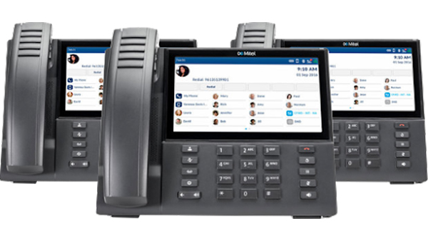 Mitel desk phones with contact lists.